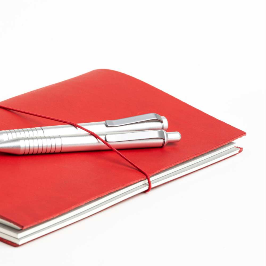 A red journal with 2 silver writing pens